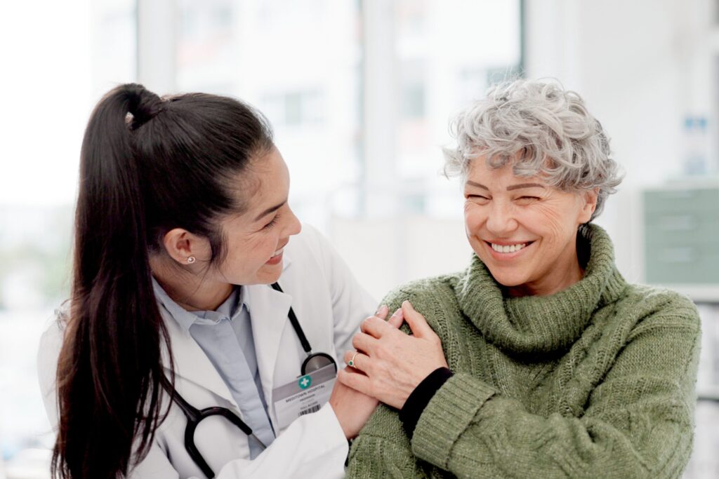 Doctor reassuring older patient during women’s health visit