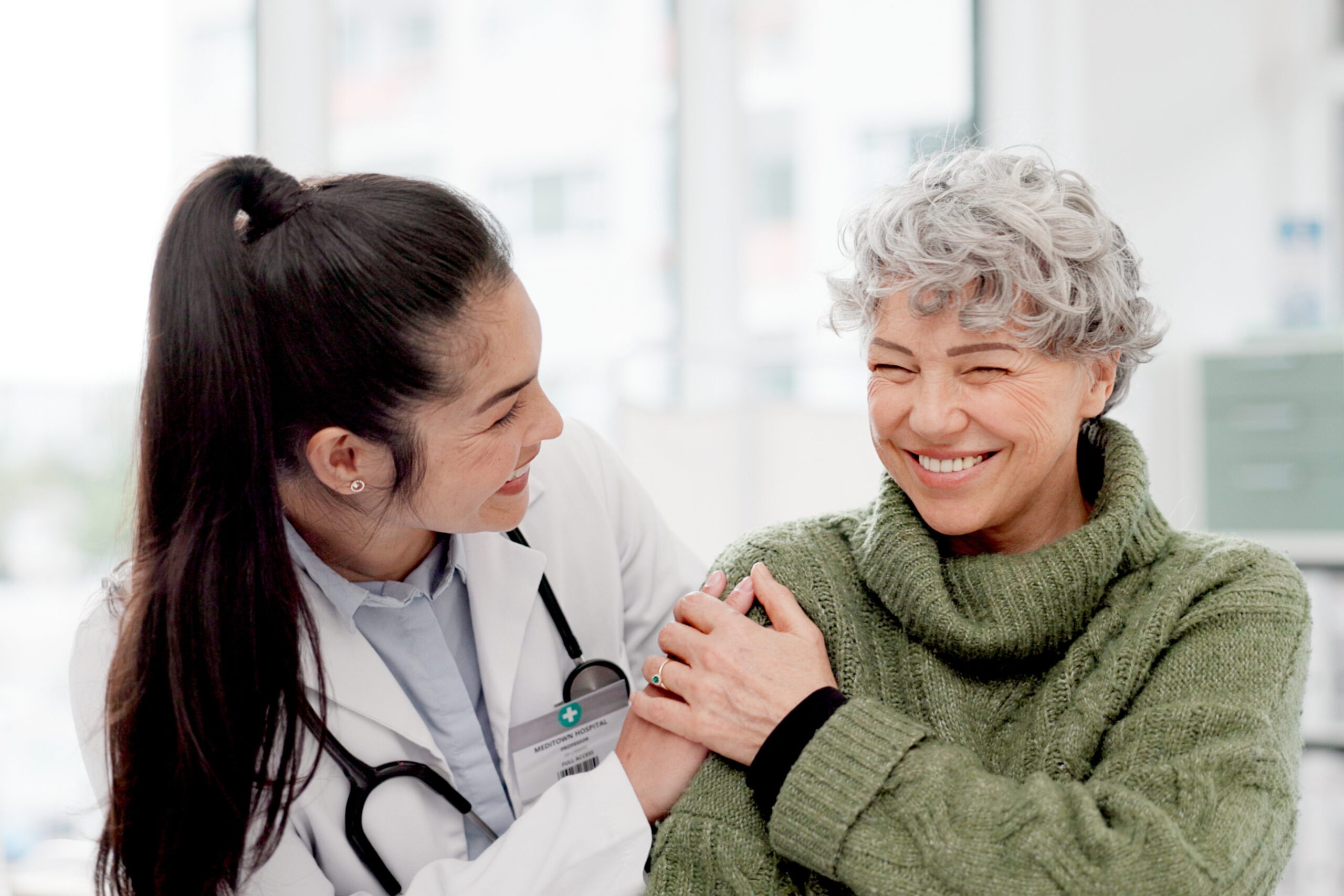 Doctor reassuring older patient during women’s health visit
