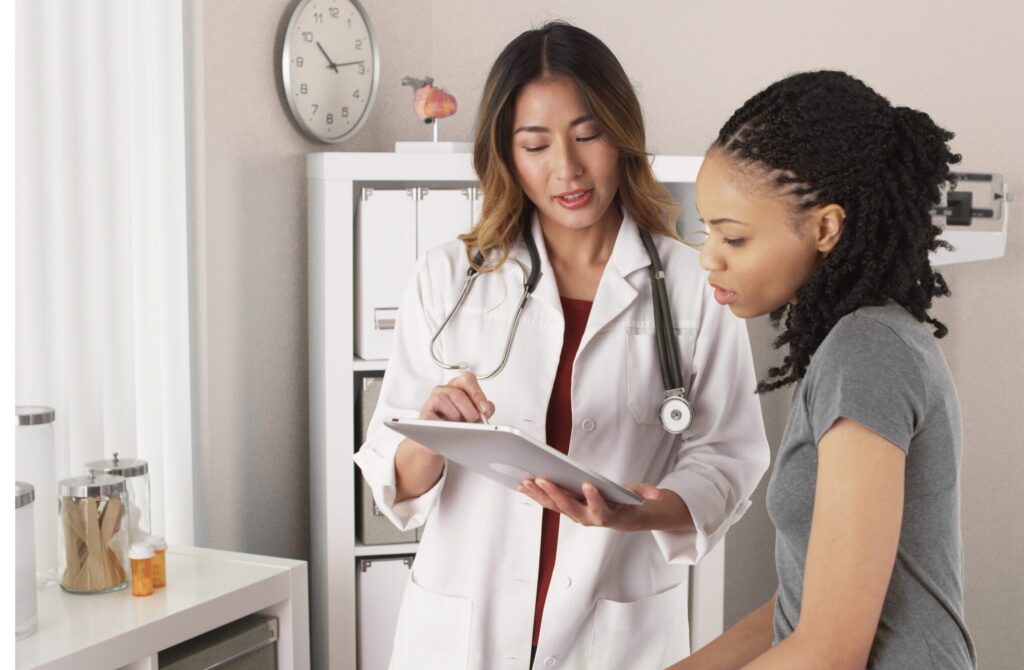 OB-GYN provider speaking with patient during women’s health visit